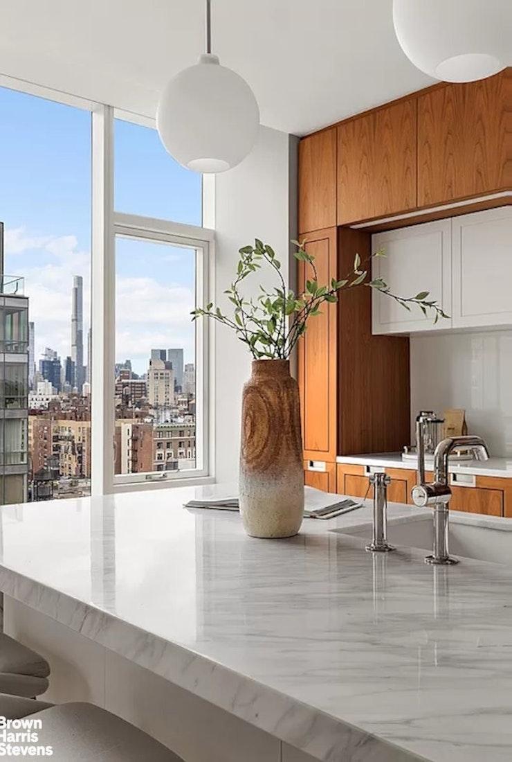 1289 Lexington Avenue, Unit 18B Manhattan, NY 10128 - Photo 4 of 10 a view of living room filled with furniture and a window