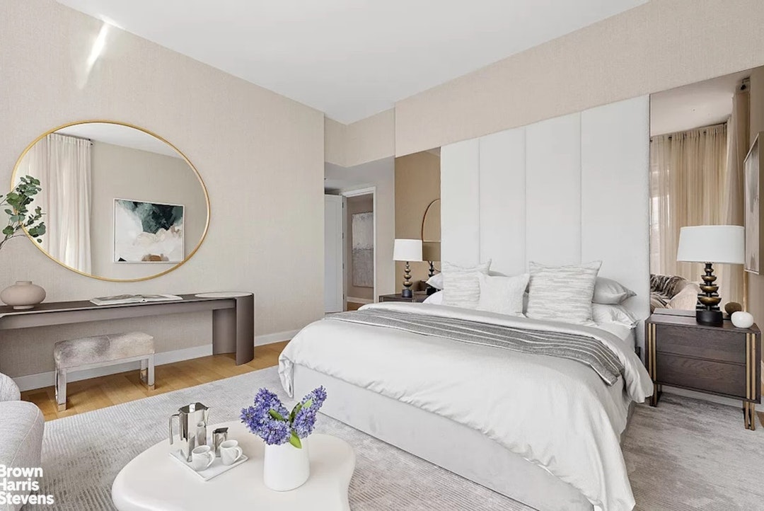 1289 Lexington Avenue, Unit 18B Manhattan, NY 10128 - Photo 5 of 10 a bedroom with a bed a mirror and vanity