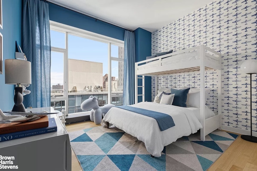 1289 Lexington Avenue, Unit 18B Manhattan, NY 10128 - Photo 7 of 10 a bedroom with a bed and a night stand