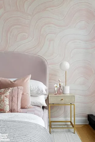 a bedroom with a bed couch and a large window