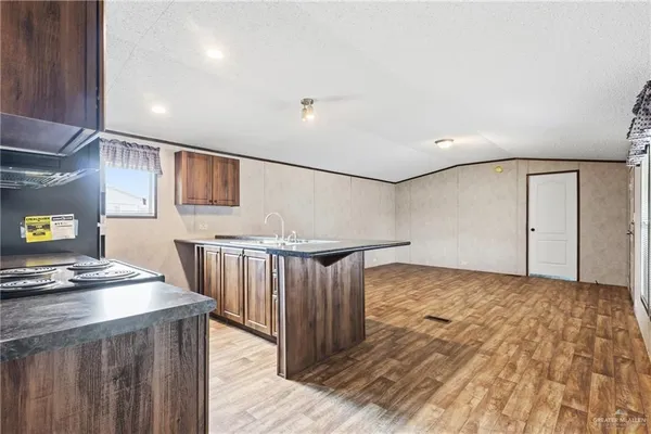 a view of kitchen with furniture and wooden floor