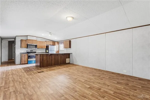 a view of kitchen with microwave and cabinets