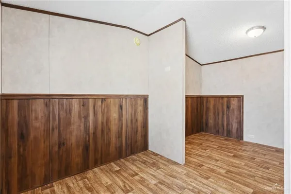 a view of a room with wooden floor