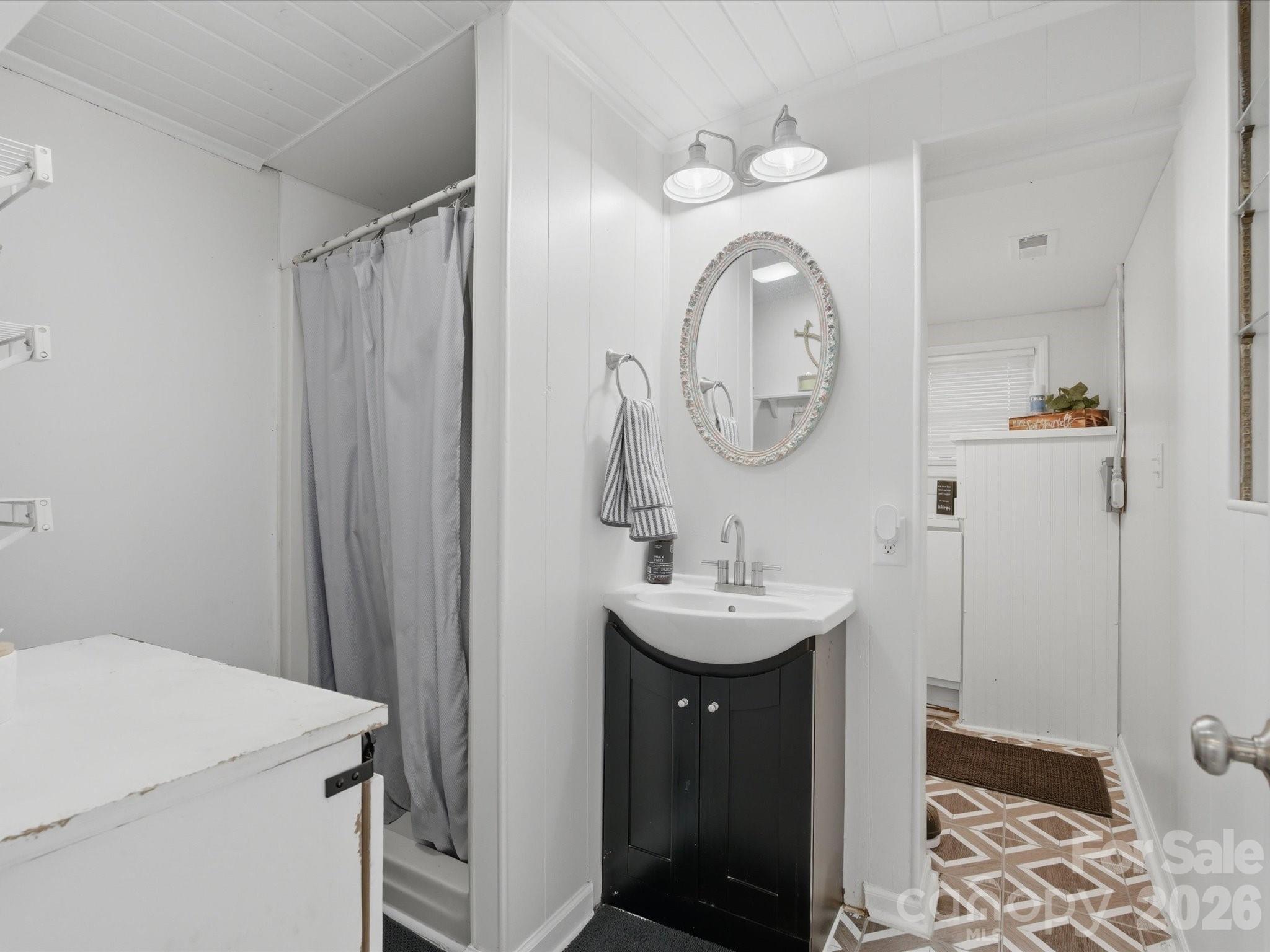 562 Lake Head Road Norwood, NC 28128 - Photo 33 of 43 a bathroom with a sink and a mirror