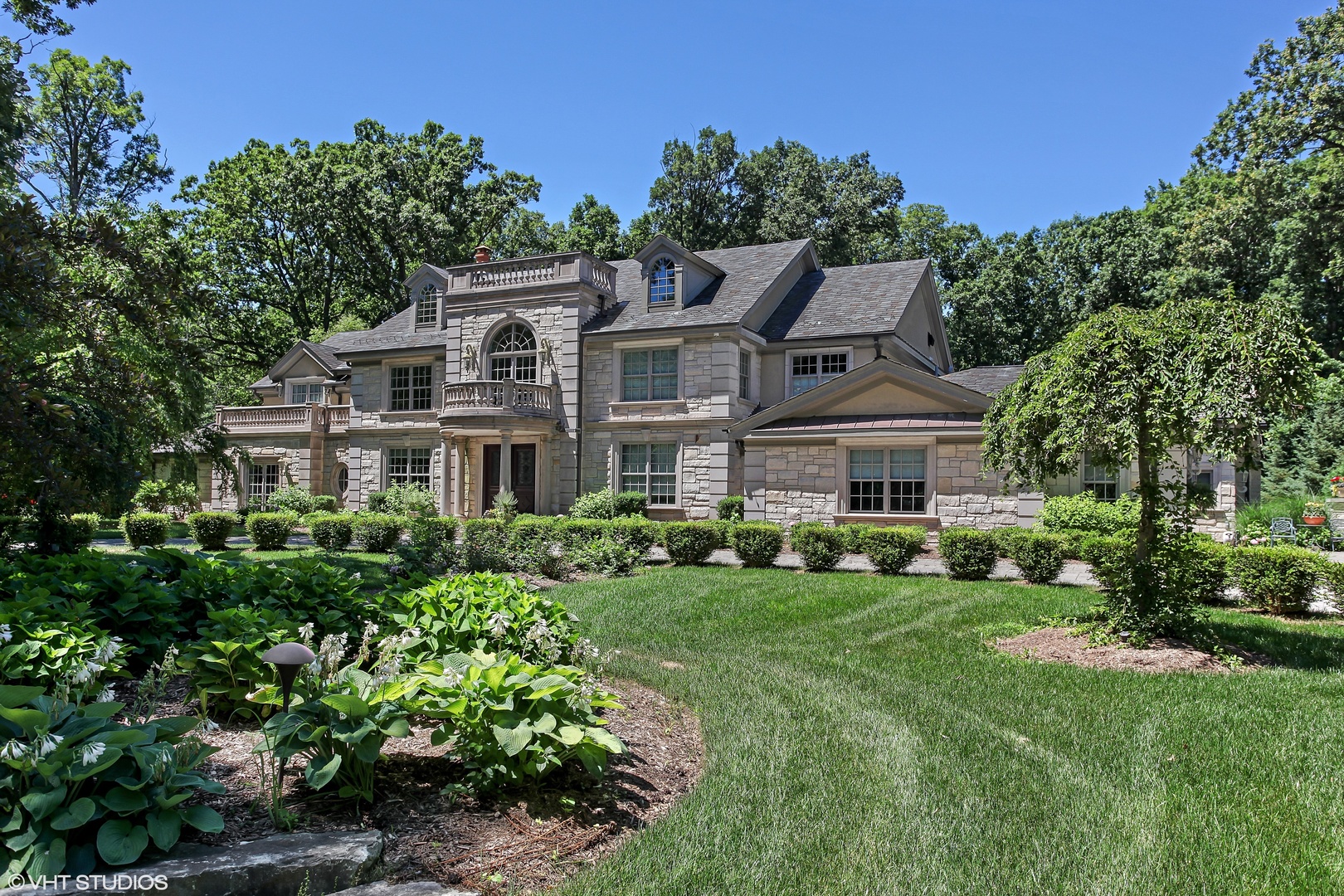 a front view of a house with a garden