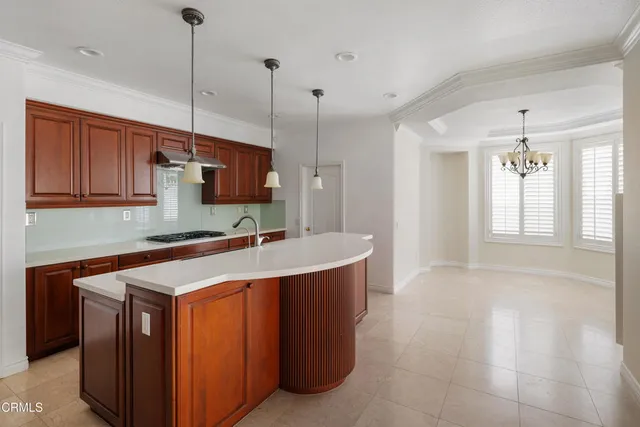 a kitchen with a sink a counter space appliances and cabinets