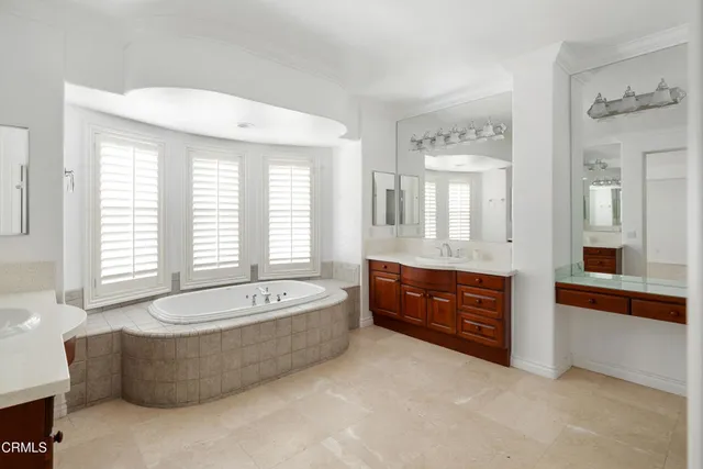 a spacious bathroom with sink shower bathtub and mirror