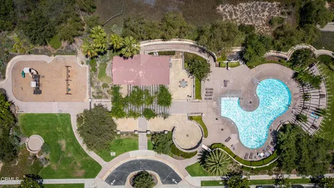 an aerial view of a swimming pool patio and outdoor seating