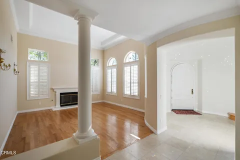 a view of a livingroom with wooden floor and a fireplace