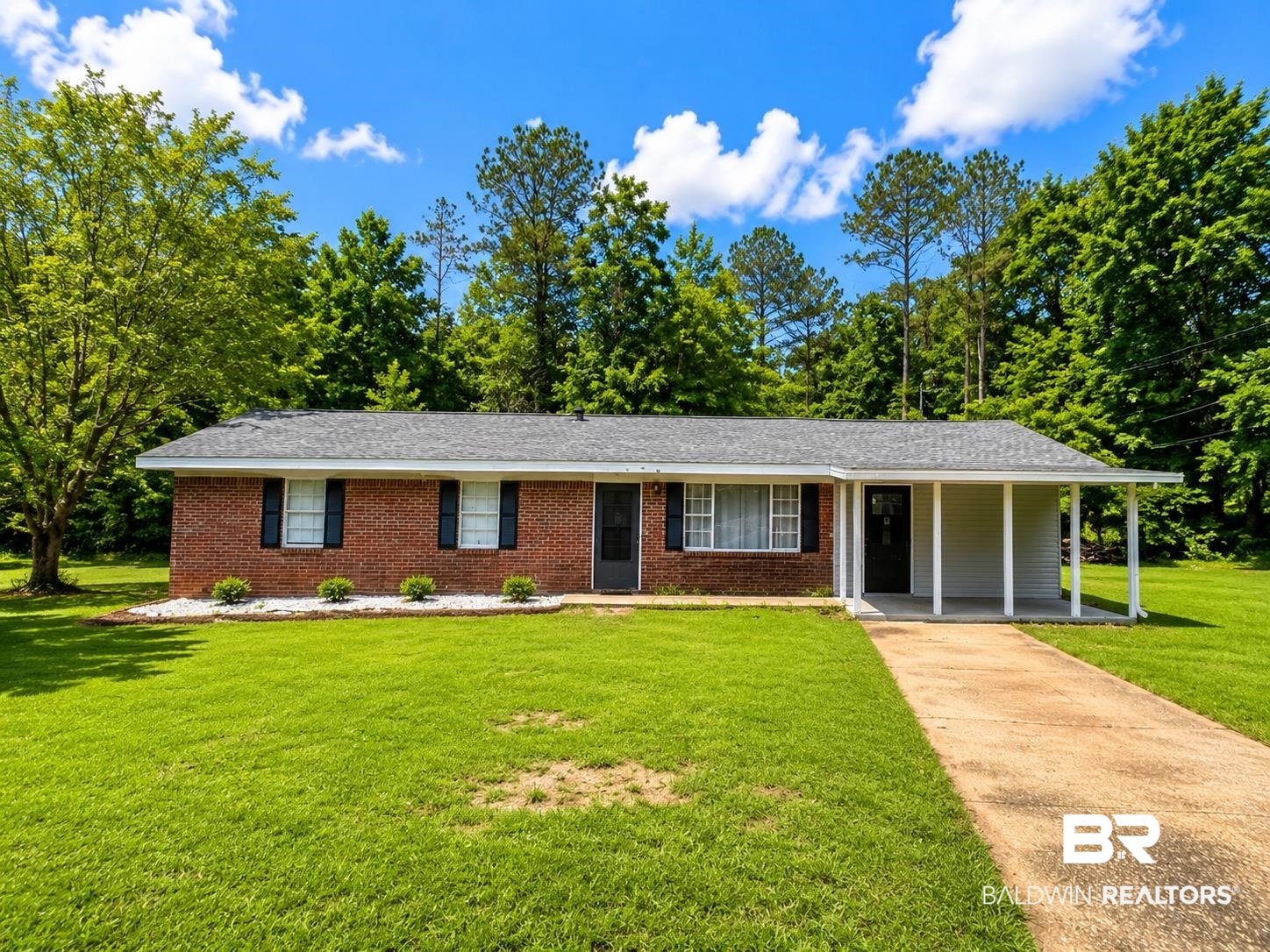 226 Elizabeth Street Evergreen, AL 36401 - Photo 4 of 35 Brick exterior with black shutters and a covered carport