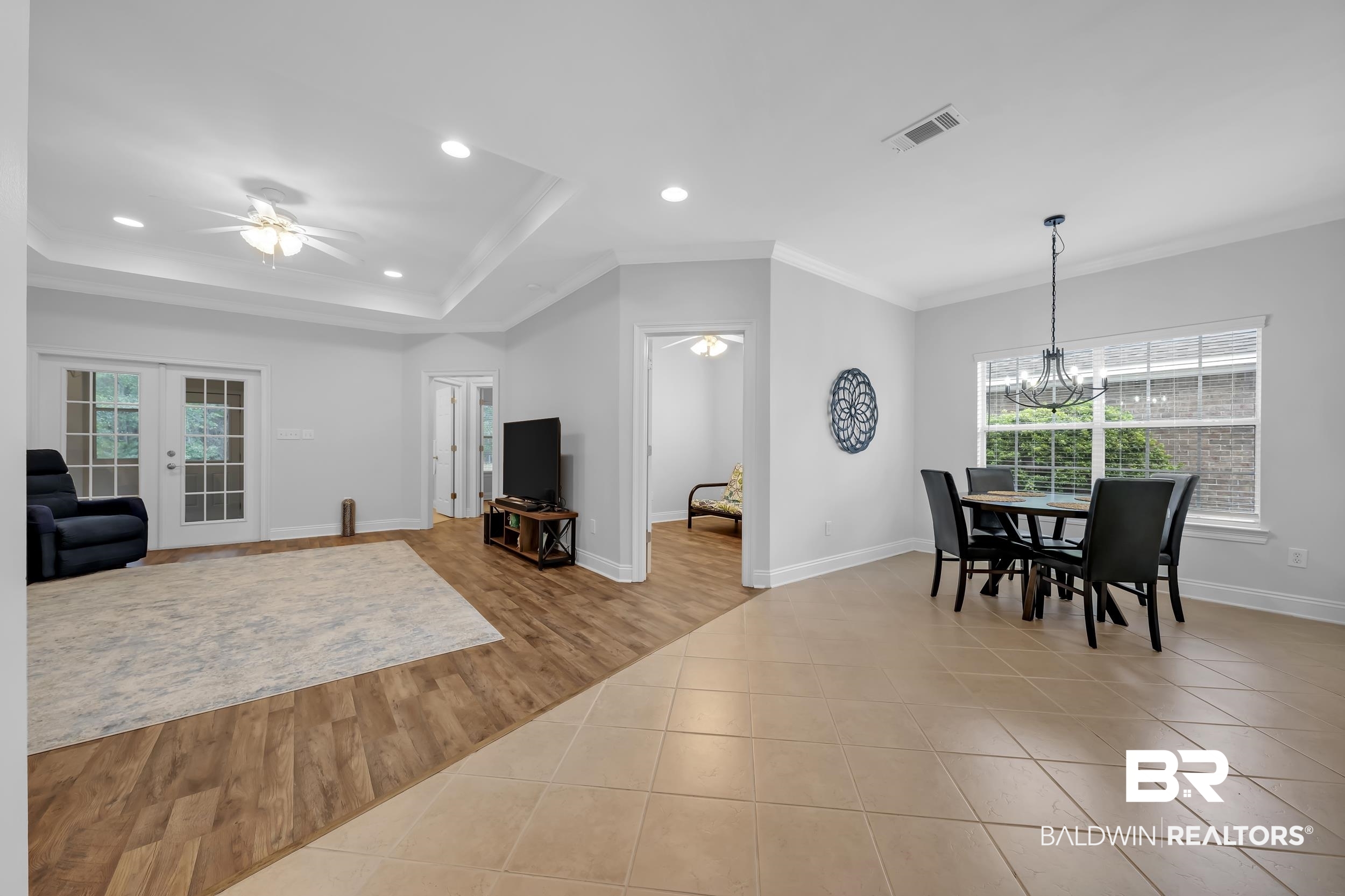 105 Mark Twain Loop Foley, AL 36535 - Photo 3 of 43 Living room with light tile patterned floors, a ceiling fan, ornamental molding, recessed lighting, and a chandelier