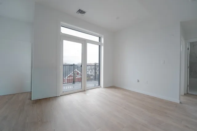 wooden floor and window in an empty room