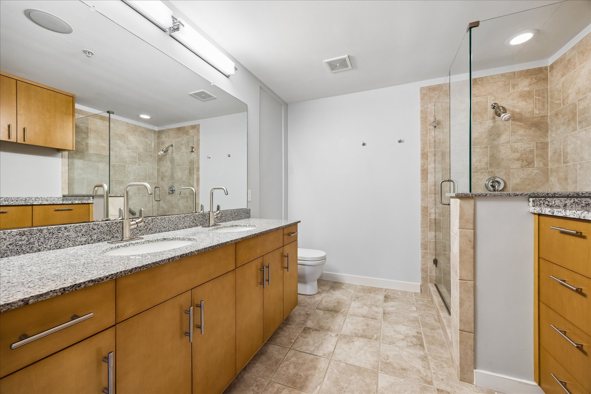 360 Nueces Street, Unit 2005 Austin, TX 78701 - Photo 11 of 35 The bathroom features a double vanity with granite countertops and plenty of storage space.