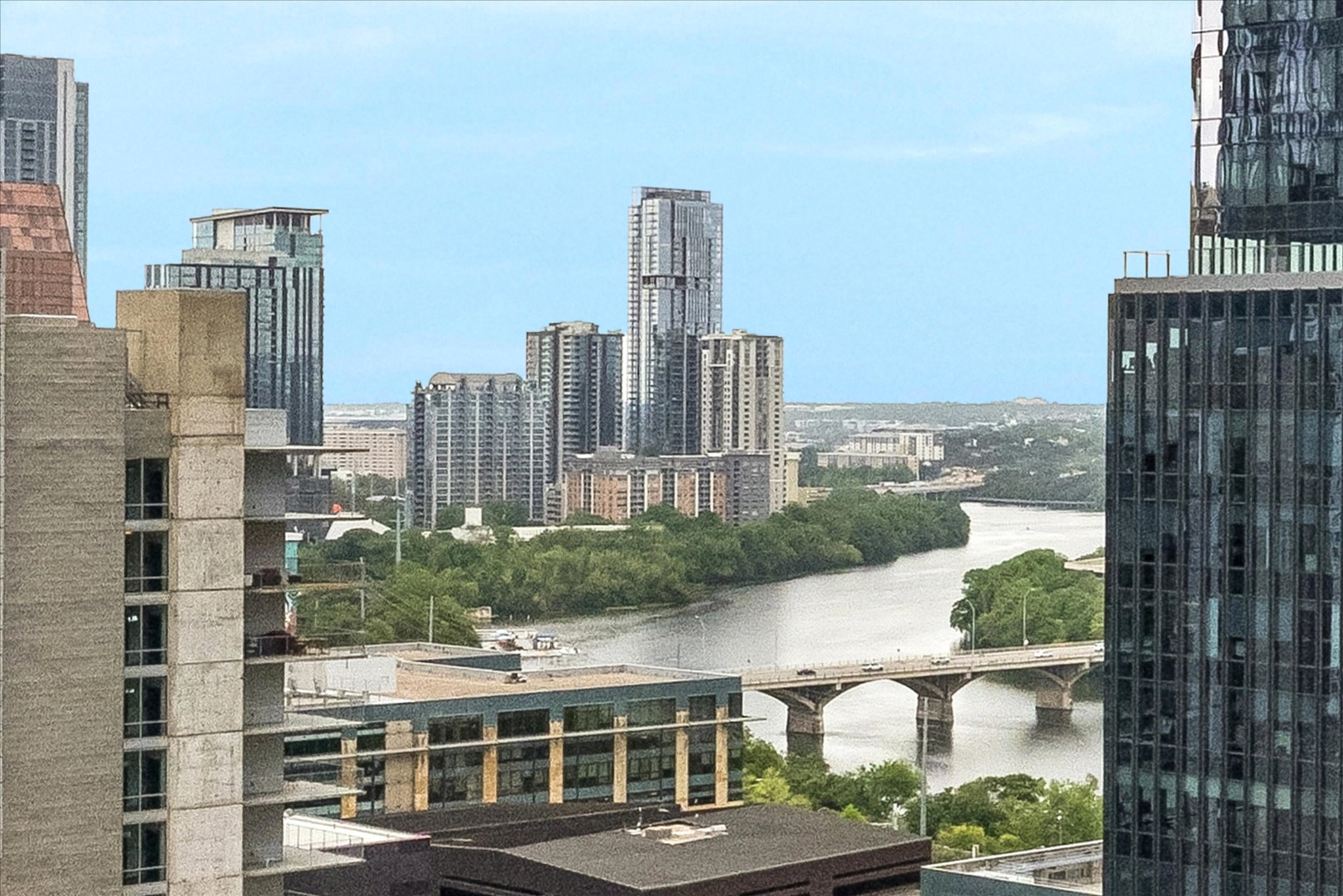 360 Nueces Street, Unit 2005 Austin, TX 78701 - Photo 18 of 35 Panoramic cityscape with a river, a bridge, and surrounding greenery