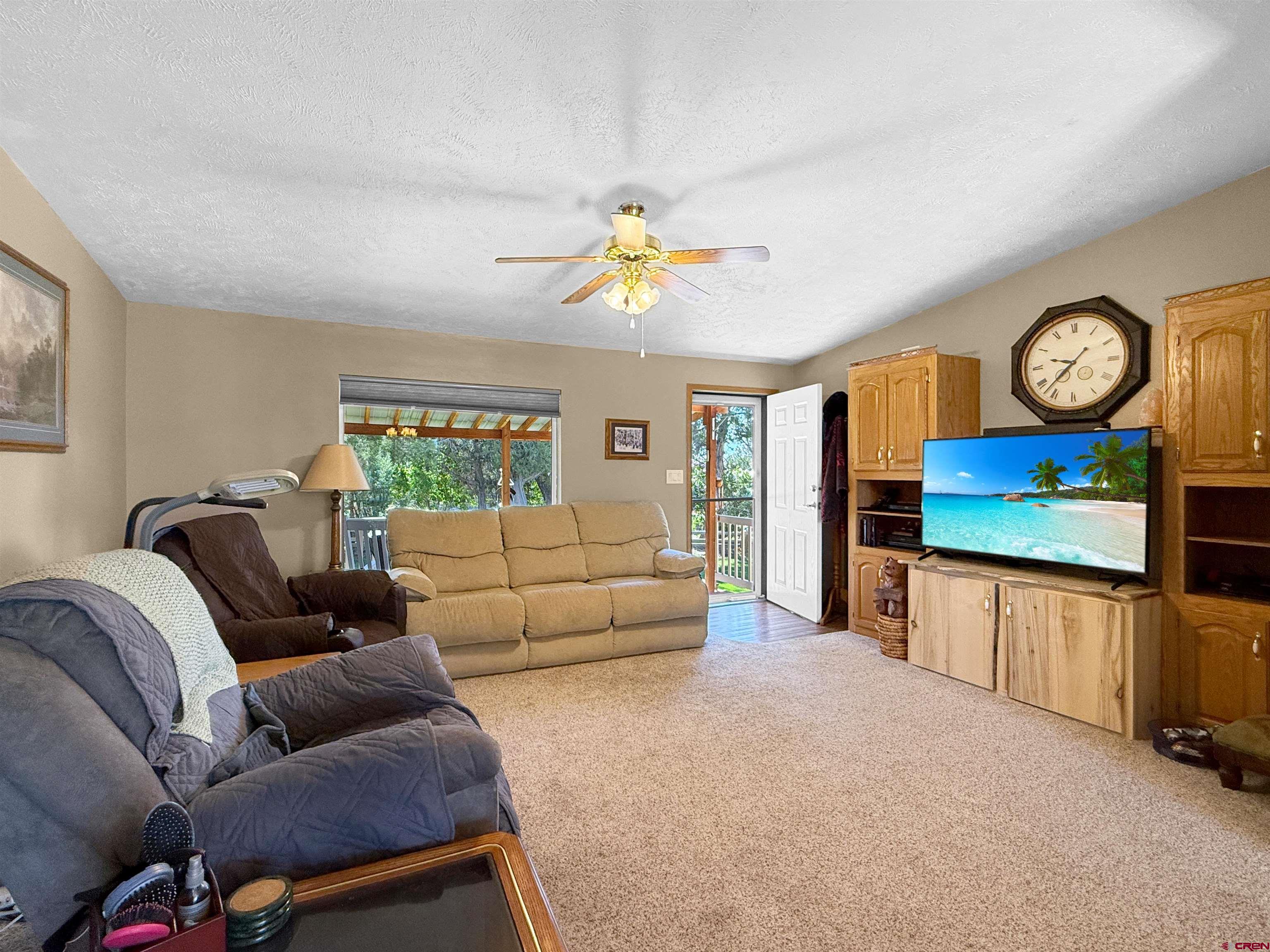 18311 2550th Road Cedaredge, CO 81413 - Photo 11 of 29 a living room with furniture and a chandelier