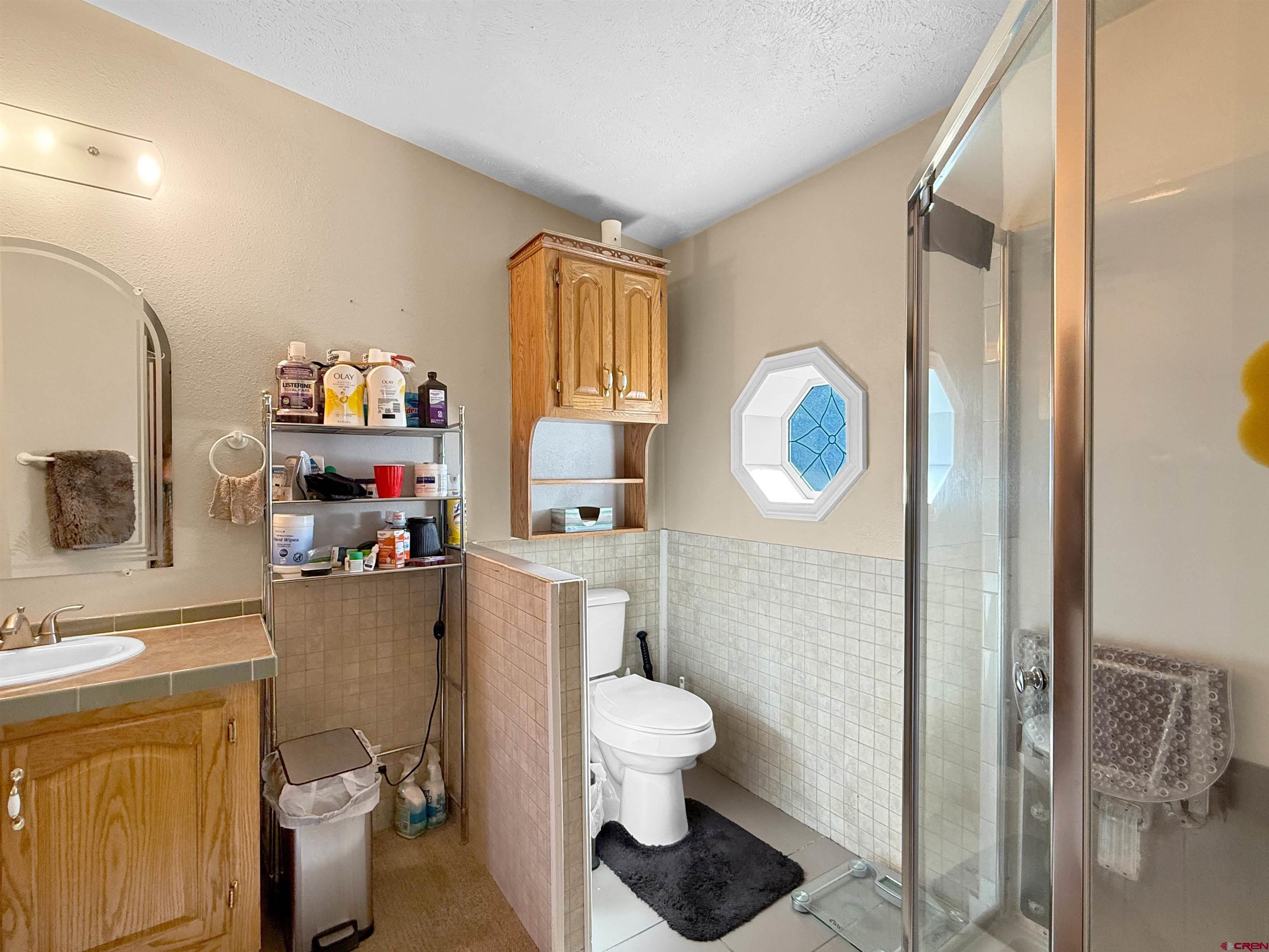 18311 2550th Road Cedaredge, CO 81413 - Photo 15 of 29 a bathroom with a toilet a sink and a shower