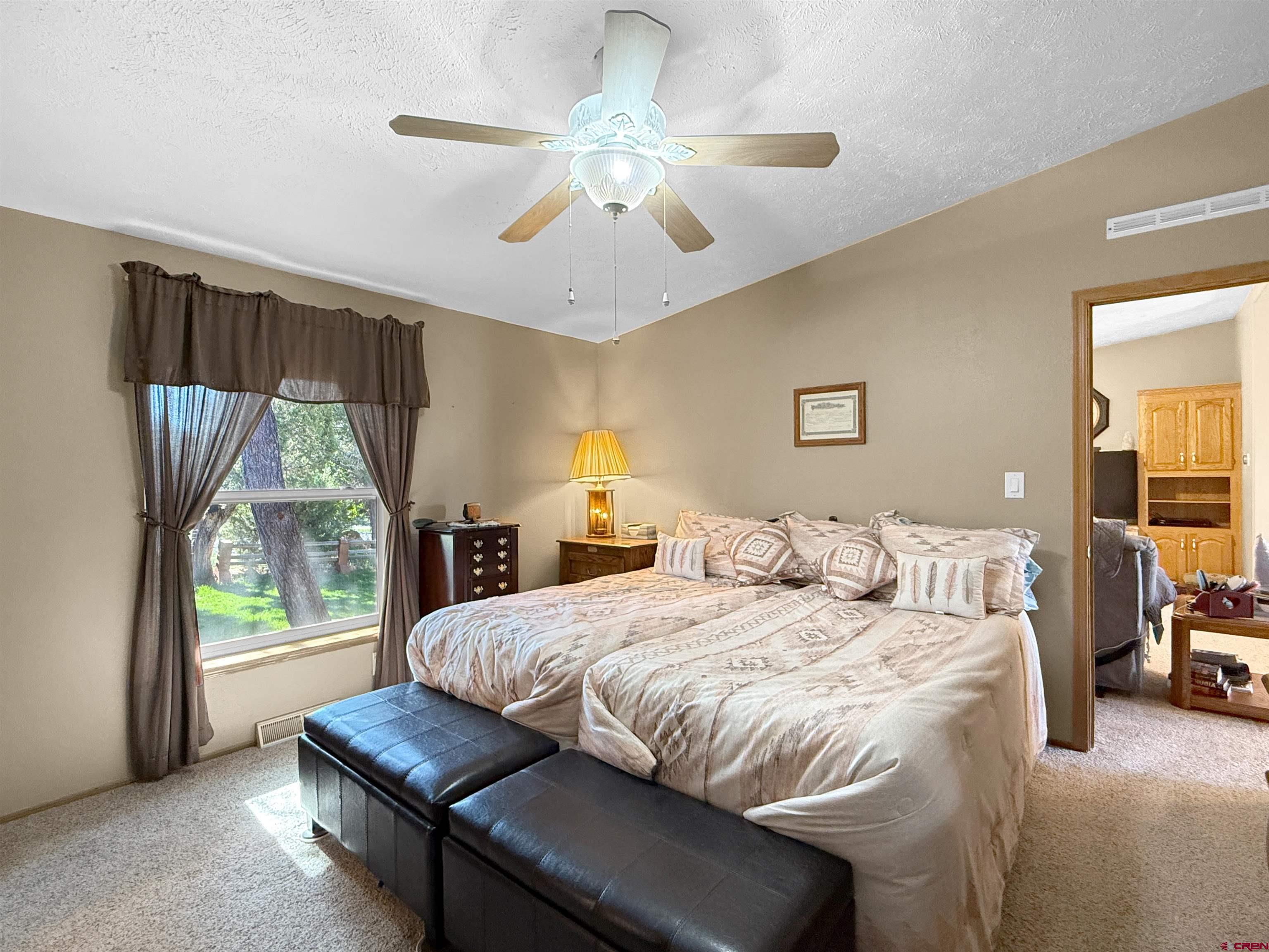 18311 2550th Road Cedaredge, CO 81413 - Photo 16 of 29 a bedroom with a bed and a large window