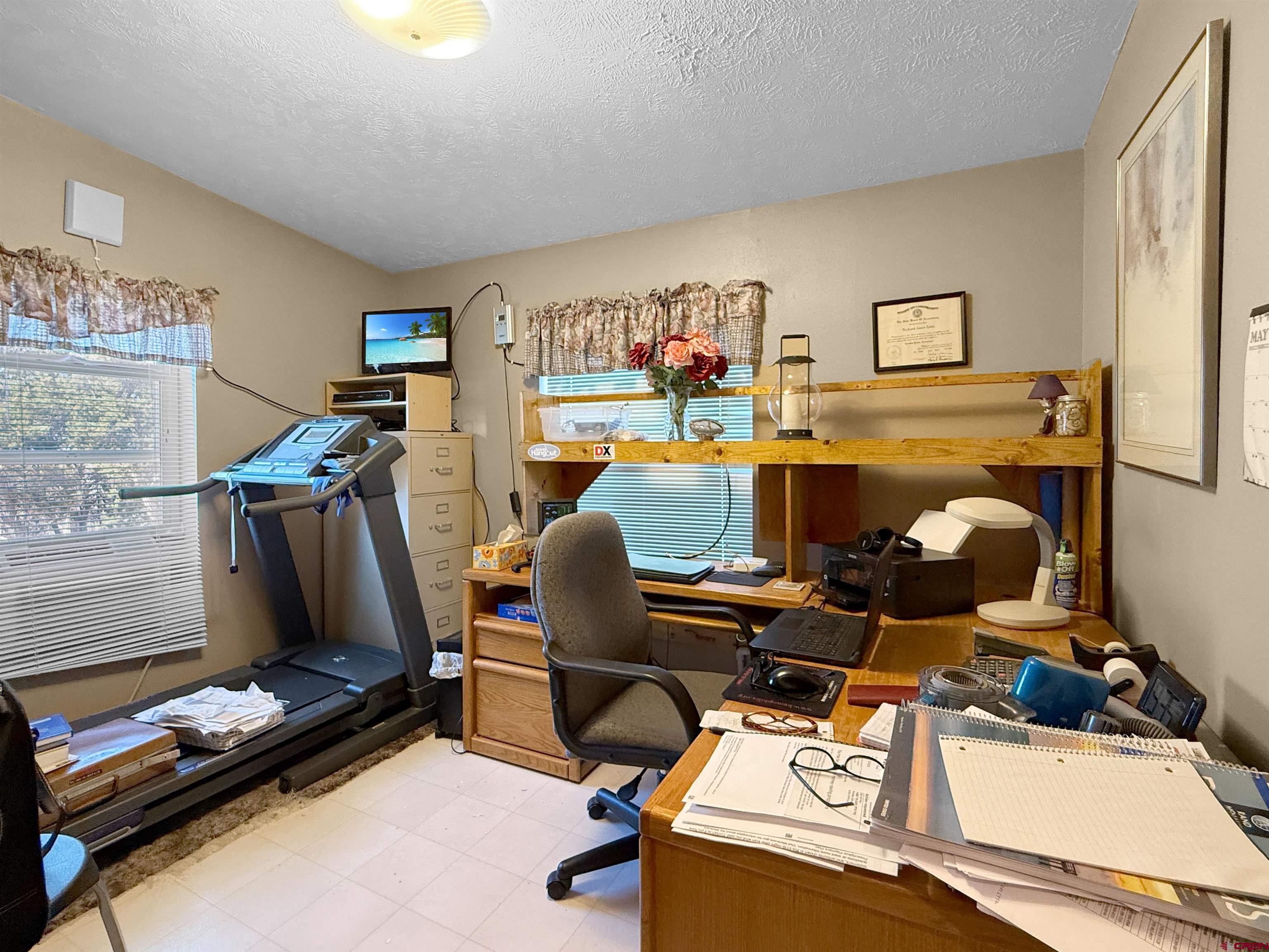 18311 2550th Road Cedaredge, CO 81413 - Photo 18 of 29 a room with furniture and flat screen tv