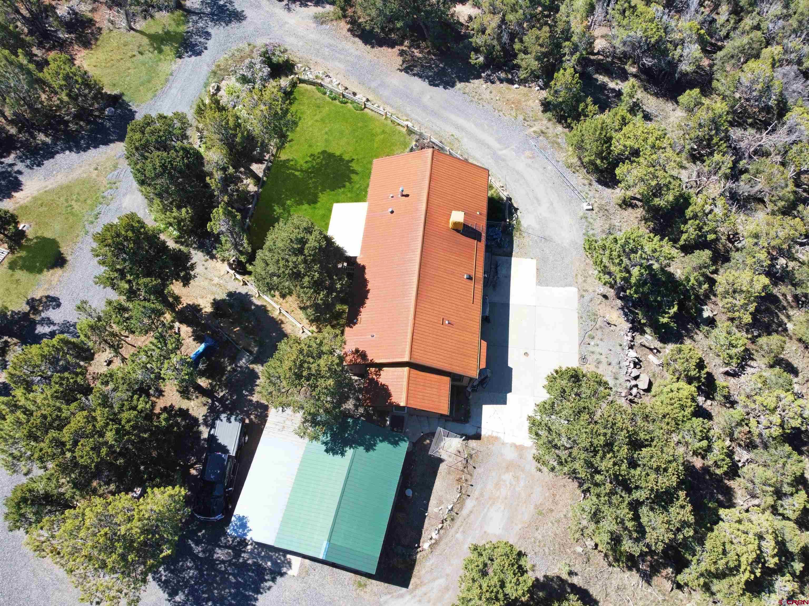 18311 2550th Road Cedaredge, CO 81413 - Photo 26 of 29 an aerial view of a house with a yard and a garden
