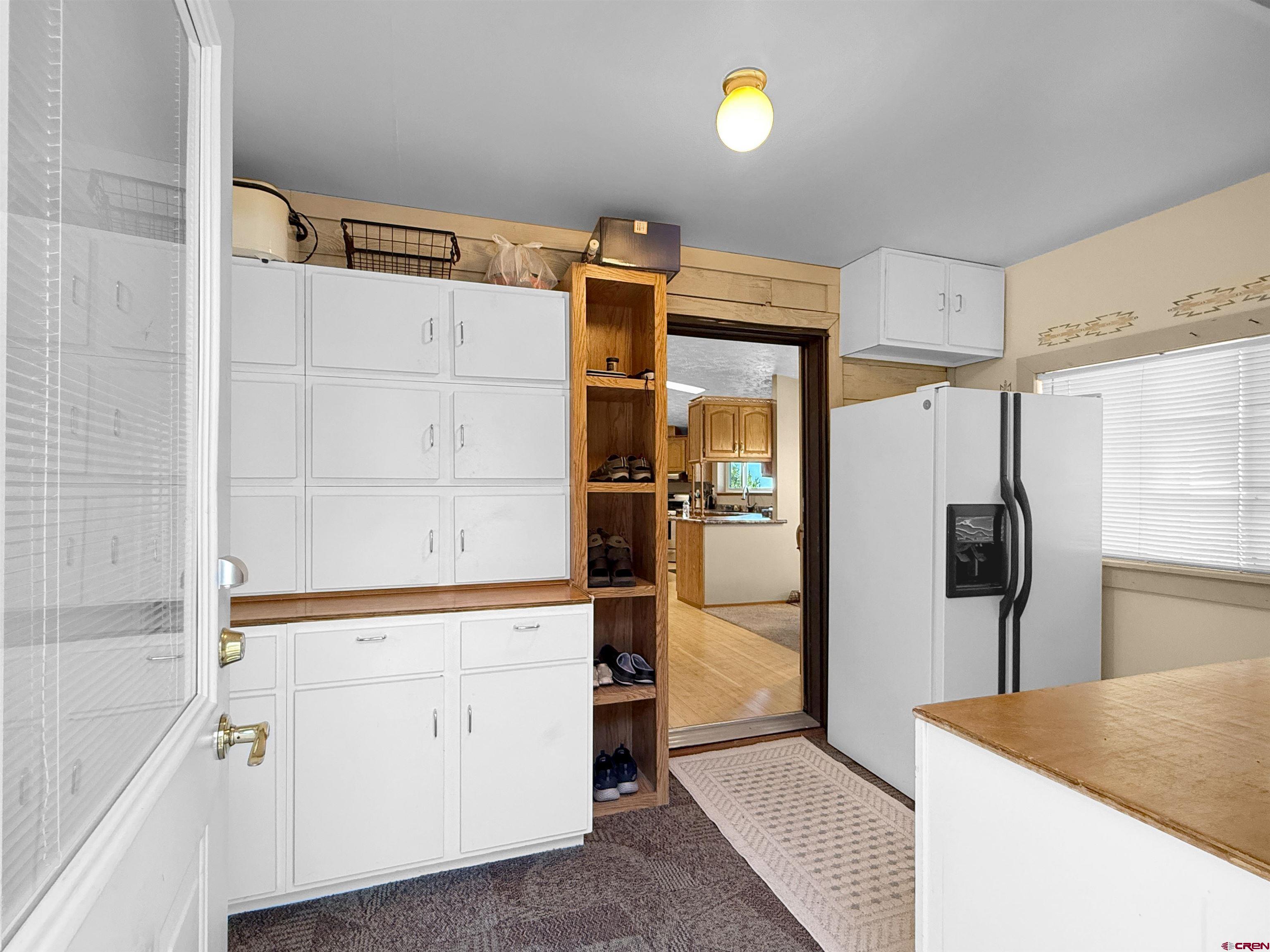 18311 2550th Road Cedaredge, CO 81413 - Photo 3 of 29 a kitchen with a refrigerator and microwave