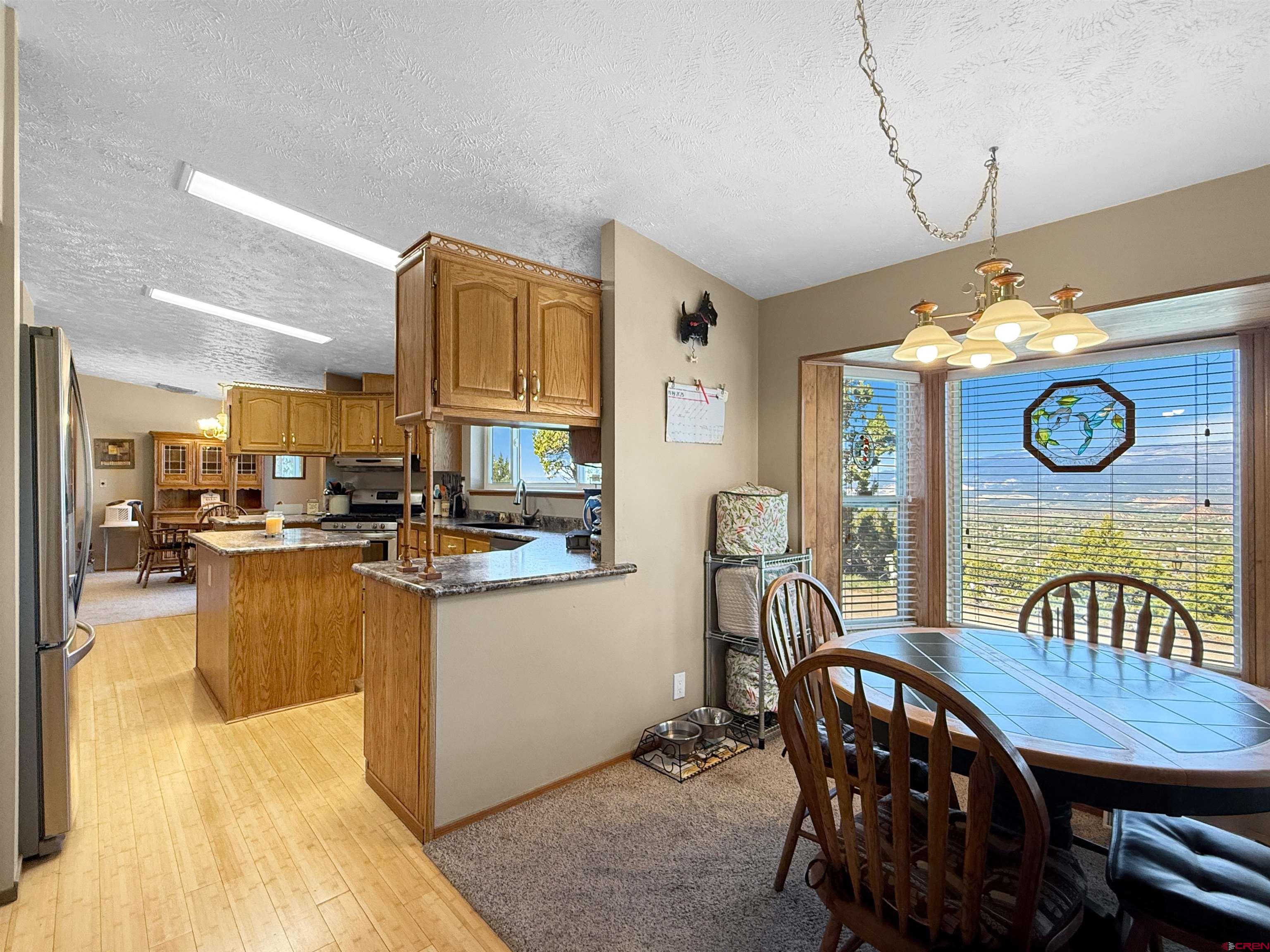18311 2550th Road Cedaredge, CO 81413 - Photo 5 of 29 a kitchen with a table chairs and a stove
