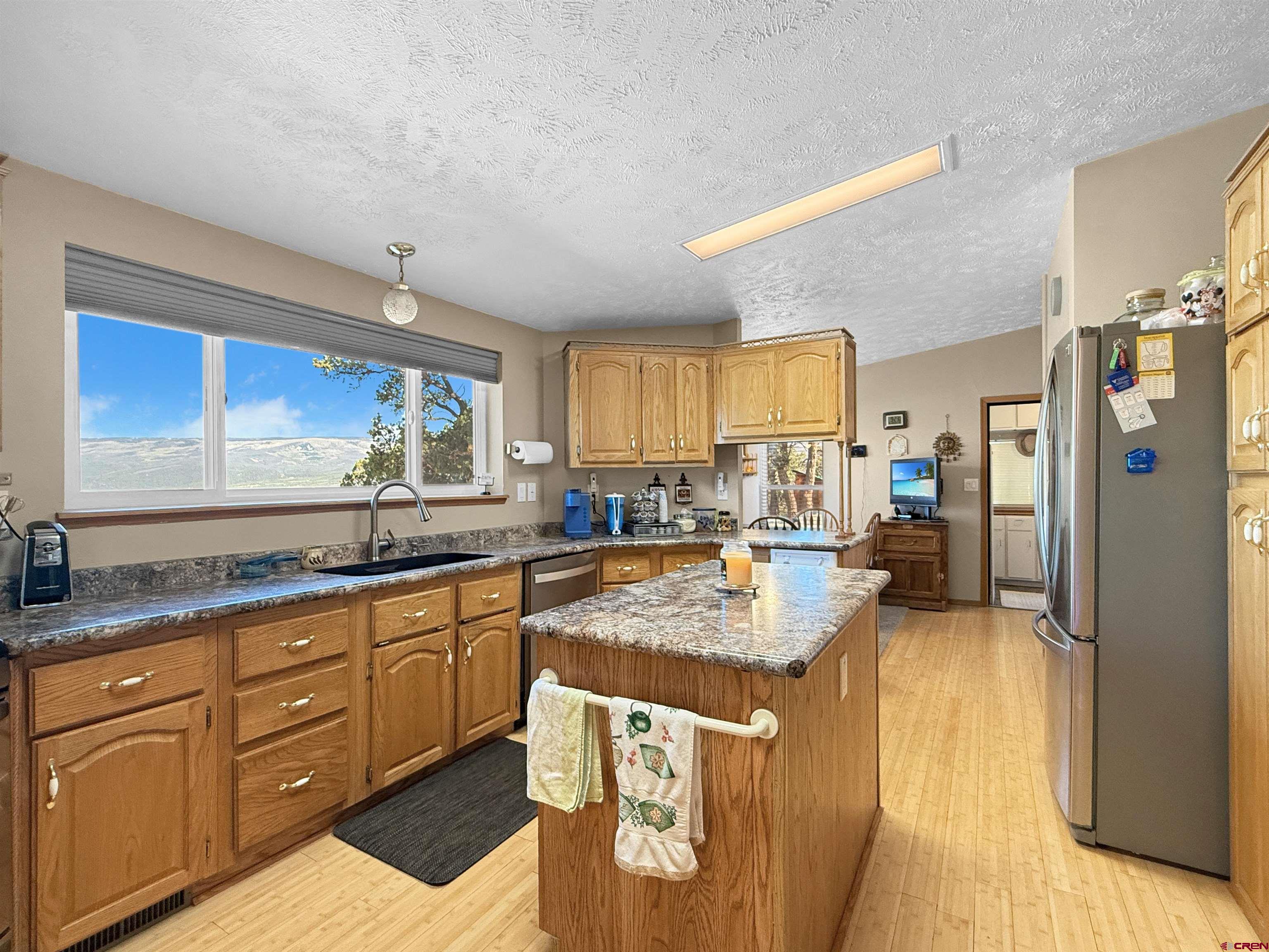 18311 2550th Road Cedaredge, CO 81413 - Photo 8 of 29 a kitchen with sink refrigerator and cabinets