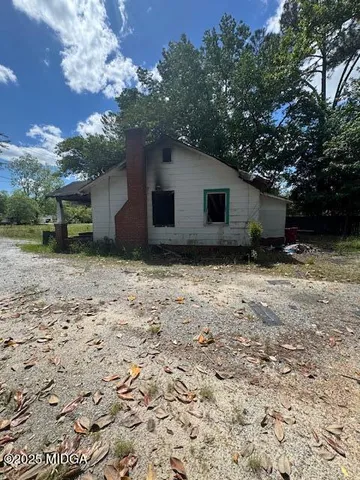 a house that has a tree in front of it