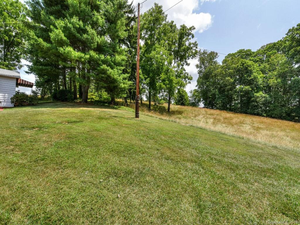 4607 Old Clyde Road Clyde, NC 28721 - Photo 14 of 24 a backyard of a house with lots of green space and garden