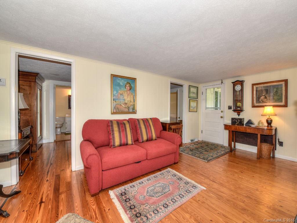 4607 Old Clyde Road Clyde, NC 28721 - Photo 19 of 24 a living room with furniture and a wooden floor