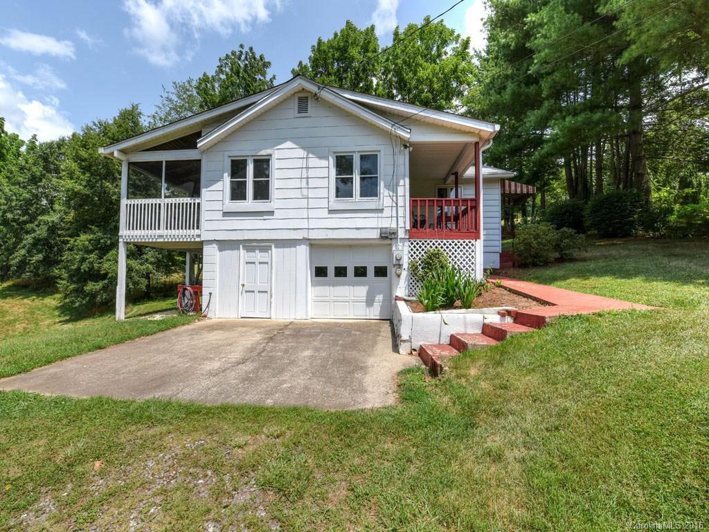 4607 Old Clyde Road Clyde, NC 28721 - Photo 20 of 24 a front view of a house with yard and green space