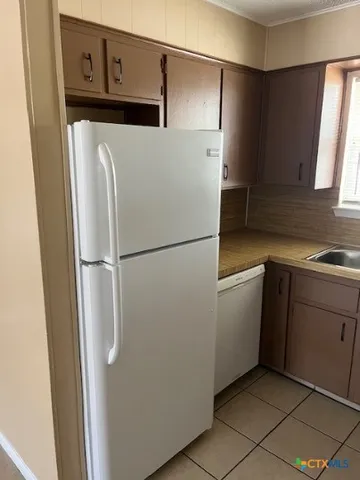 a kitchen with stainless steel appliances a refrigerator and cabinets