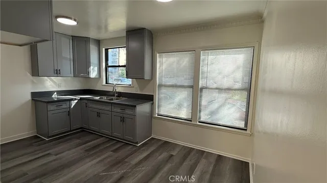 a kitchen with granite countertop a stove and a refrigerator