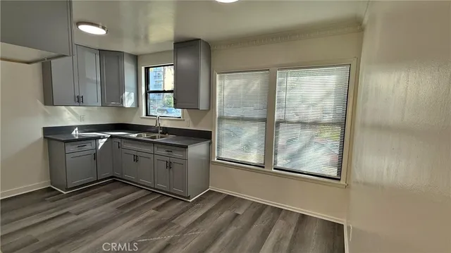 a kitchen with granite countertop a stove and a sink