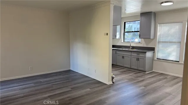 a kitchen with granite countertop a refrigerator and a stove top oven