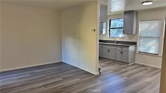 a spacious bathroom with a granite countertop sink and a mirror