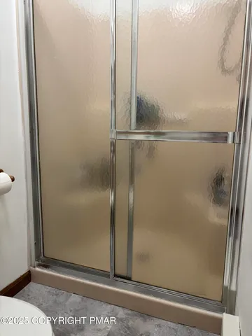 a bathroom with a glass shower door