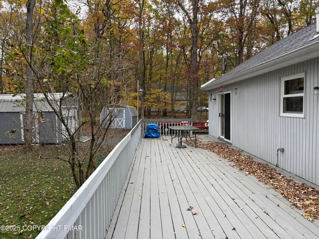 a view of balcony with furniture and trees