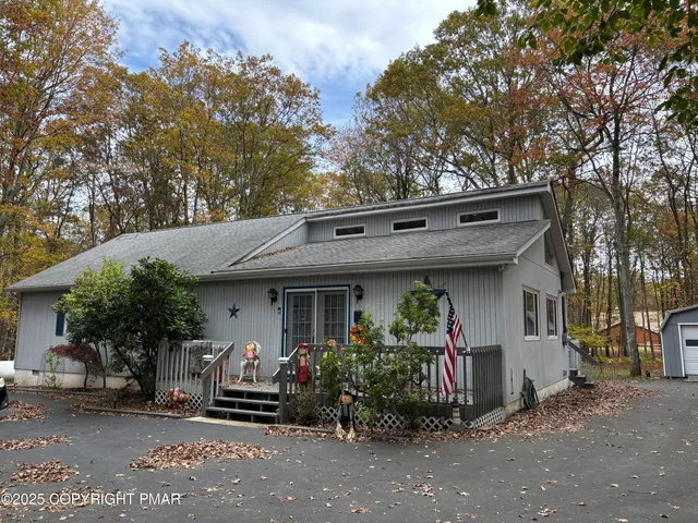 a front view of a house with plants
