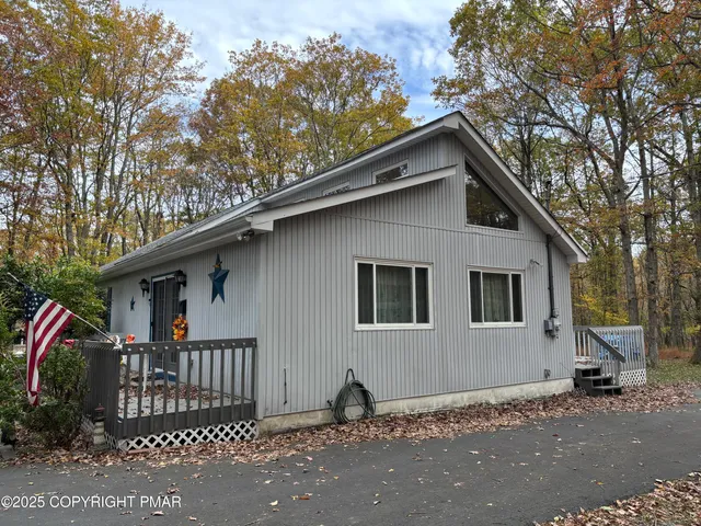 a house that has a tree in front of the house