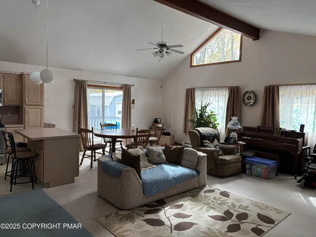 a living room with furniture and a mirror