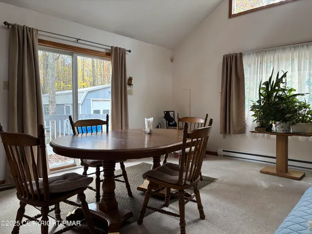 a view of a dining room with furniture and window