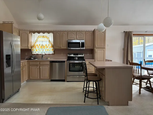 a kitchen with a stove a sink and a refrigerator