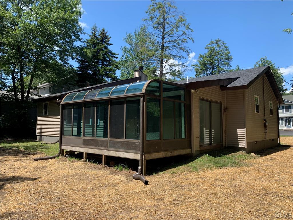 3122 Sycamore Pocono Summit, PA 18346 - Photo 3 of 3 a view of a house with a large window and wooden fence