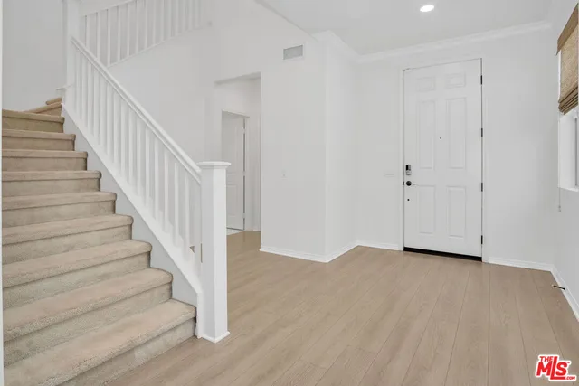 a view of an entryway with wooden floor