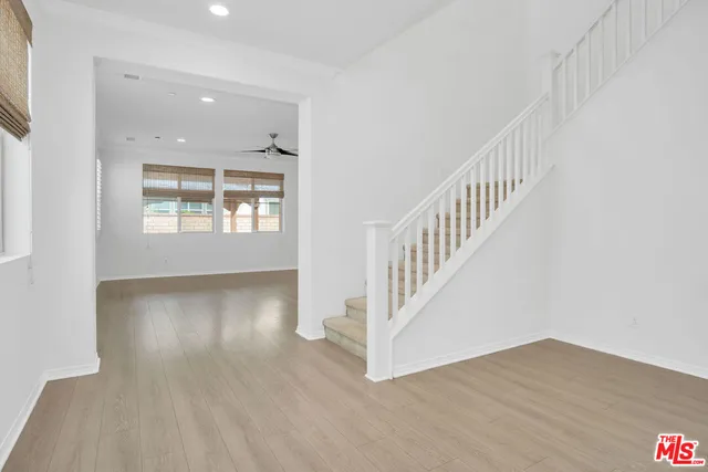 a view of an entryway with wooden floor