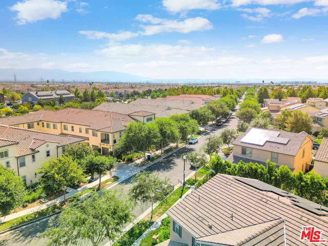 a view of a city with lawn chairs and large tree