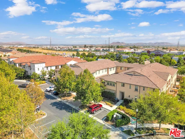 an aerial view of a house with a yard and balcony