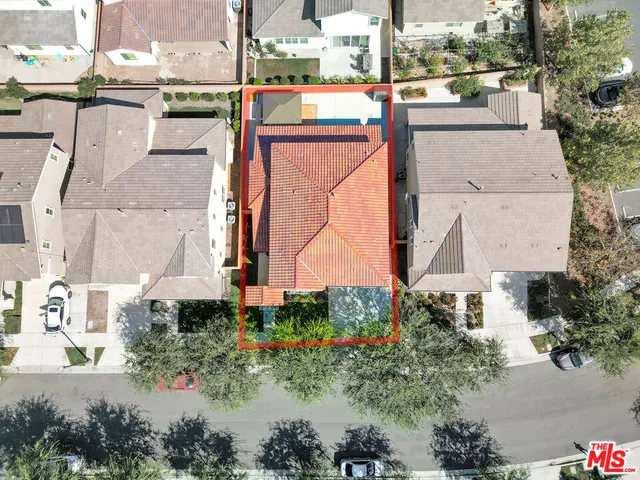 an aerial view of a house with a yard and garden