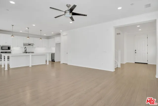 a view of a kitchen with a sink and a stove top oven