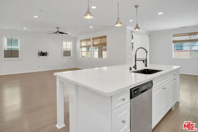 a kitchen with a sink a counter space and a window